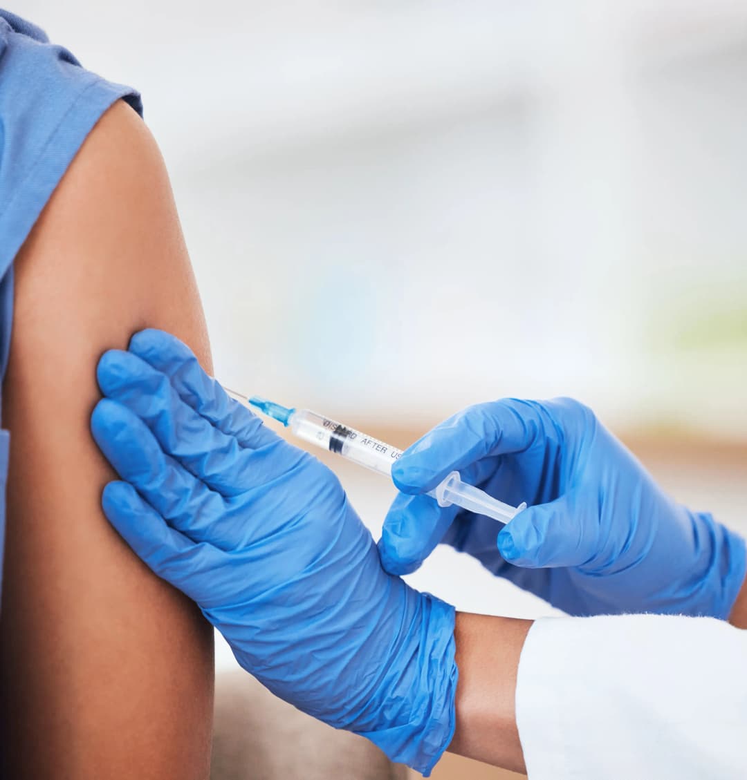 Pharmacist administering a flu shot at Five Star Pharmacy